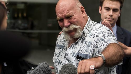 Peter Nixon shows the Queensland Fire and Rescue ring he wears in memory of his father. (Image: AAP)