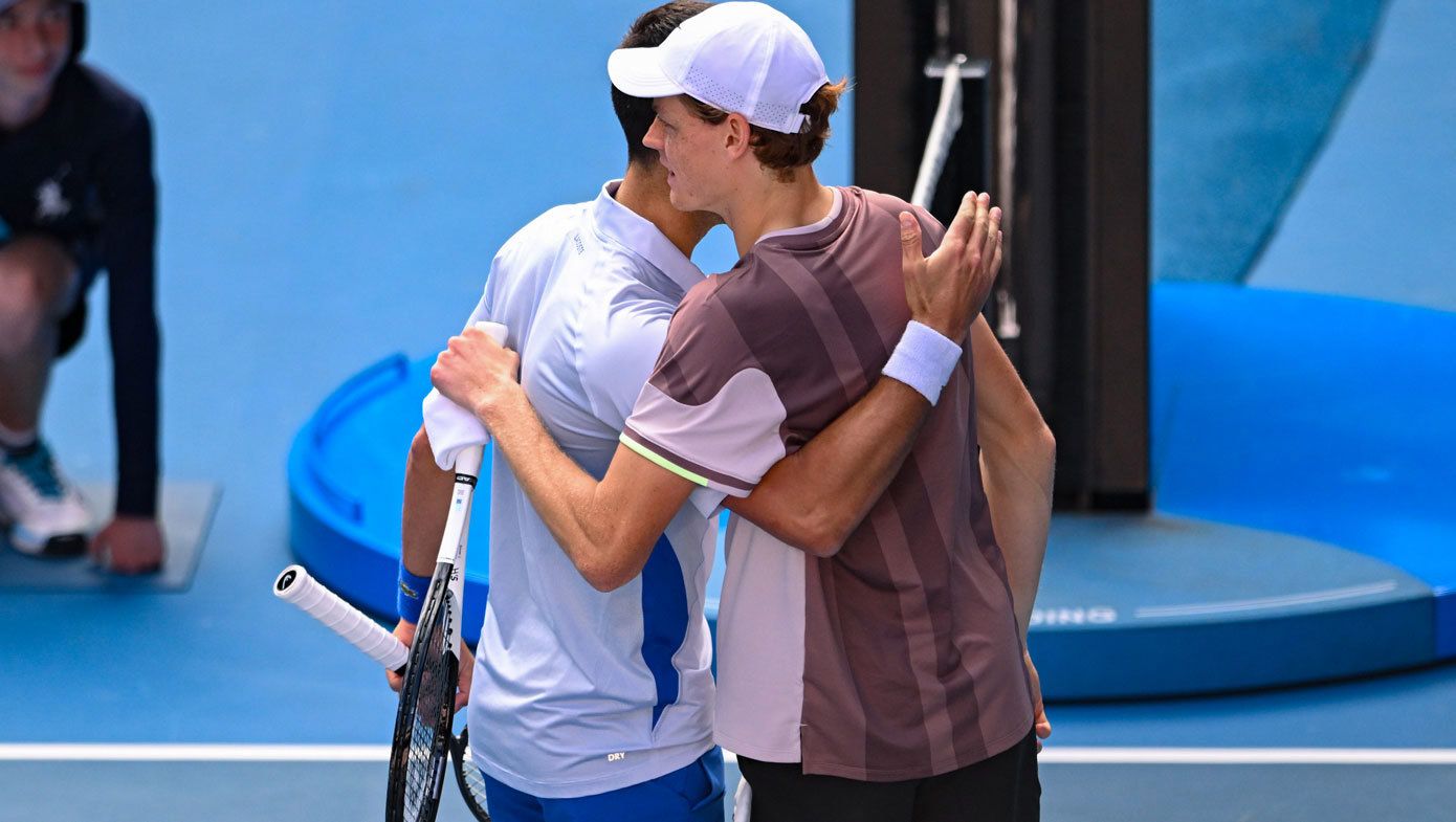 Jannik Sinner is greeted at the net by Novak Djokovic after their Australian Open semi final in 2024.