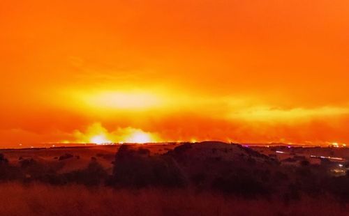 Firey red skies at the height of the blazes on Saturday night. . (Facebook: Hangingpixels Photo Art)