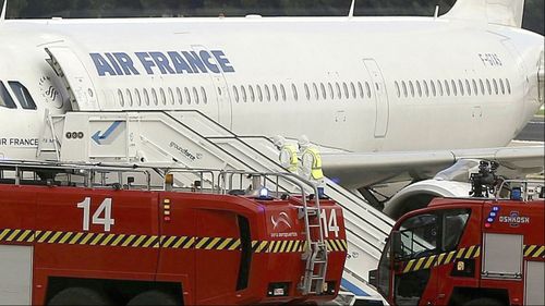 Medical staff in protective suits enter the isolated Air France Airbus in Madrid. 