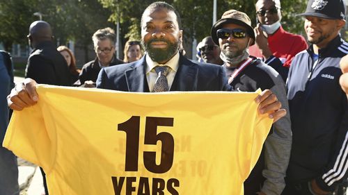 Juwan Deering holds a t-shirt from the National Organization of Exonerees that displays the amount of time her served in prison after he was released from custody. 