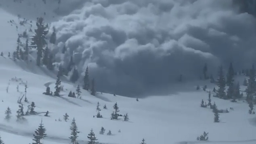 One of the snowmobiles filmed the avalanche as it rushed towards the group.