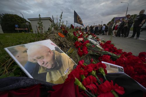 A portrait of the owner of private military company Wagner Group Yevgeny Prigozhin lays at an informal memorial next to the former 'PMC Wagner Centre' in St. Petersburg, Russia, Thursday, Aug. 24, 2023.  