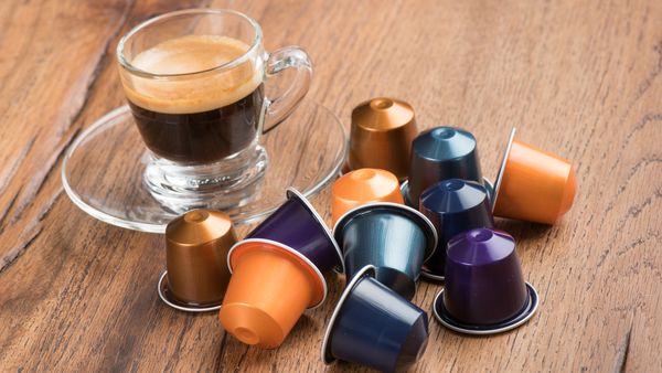 Berlin, Germany - January 23, 2015: Cup of Coffee with Nestle Nespresso Capsules on a wooden table