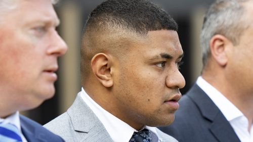 NRL Manly player Manase Fainu, centre, departs Parramatta Courthouse during a lunch break.