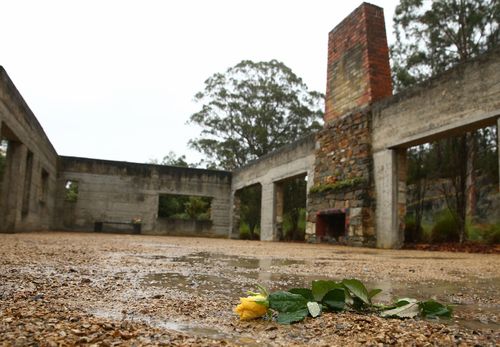 A yellow rose is seen in what once was the Broad Arrow Cafe, the first location the Port Arthur gunman began shooting.