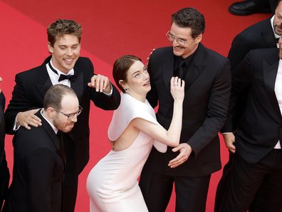 Emma Stone tries to avoid a bee next to Austin Butler, Pedro Pascal and director Ari Aster, Joaquin Phoenix, Clifton Collins Jr., Luke Grimes and Micheal Ward at the premiere of Eddington during the 78th annual Cannes Film Festival, in Cannes, France, 16 May 2025