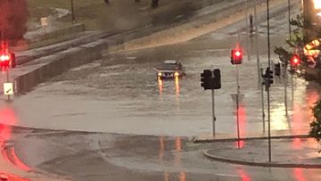 Local Amanda Langer came across a car stuck in floodwaters at the Eastland Intersection in Hobart.