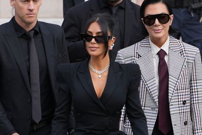 PARIS, FRANCE - MAY 13: Kim Kardashian and Kris Jenner exit the trial at the Palais de Justice ; Kim Kardashian wears sunglasses by Alaia, a black dress with power shoulders / shoulder pads / puff shoulders and low-neck by John Galliano, a necklace by Samer Halimeh, Repossi diamond earcuffs, Brioni Raymond earrings, at the Palais de Justice, on May 13, 2025 in Paris, France. (Photo by Edward Berthelot/GC Images)