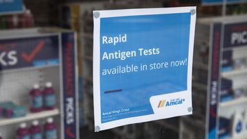 A sign on Amcal Chemist at Kings Cross informs customers that they do have Rapid Antigen Tests in store. 