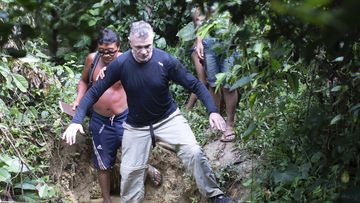 British journalist Dom Phillips, right, and a Yanomami Indigenous man walk in Maloca Papiu village, Roraima state, Brazil, Nov. 2019. Phillips and Indigenous affairs expert Bruno Araujo Pereira have been reported missing in a remote part of Brazil&#x27;s Amazon region, a local Indigenous association said Monday, June 6, 2022. (AP Photo/Joao Laet)