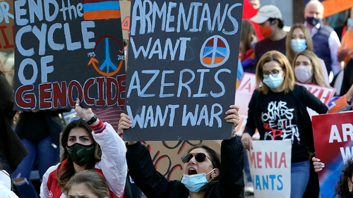 Pro-Armenian protesters display placards while calling for an end to hostilities in Nagorno-Karabakh, also known as Artsakh, during a demonstration, Sunday, Oct. 11, 2020, in Boston. The latest outburst of fighting between Azerbaijani and Armenian forces began Sept. 27, 2020, and marked the biggest escalation of the decades-old conflict over Nagorno-Karabakh. (AP Photo/Steven Senne)