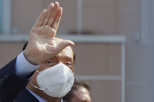 Silvio Berlusconi waves as he leaves the San Raffaele hospital in Milan, Italy, on Sept. 14, 2020. 