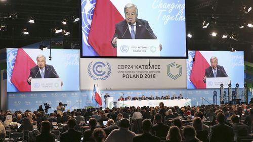 UN Secretary General Antonio Guterres appears on screens when delivering a speech during the opening of COP24 UN Climate Change Conference 2018 in Katowice, Poland.