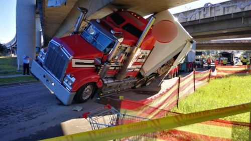 Beer truck becomes jammed under M4 overpass in Sydney 