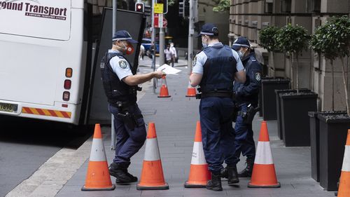 Police officers pictured outside one of the Sydney quarantine hotels.