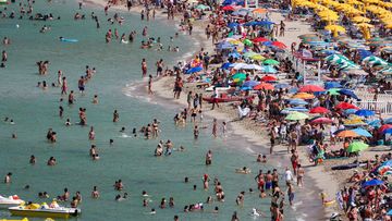 People cool off at Mondello beach, during a heatwave across Italy, in Palermo, Italy.