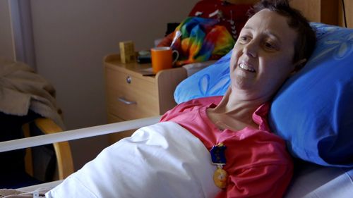 Connie wearing her medal of the Order of Australia in her hospice bed in Canberra. (Love Your Sister)