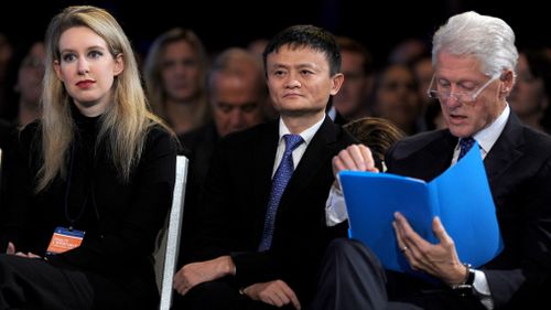 Holmes with Alibaba founder Jack Ma and former US president Bill Clinton in 2015. (PA/AAP)