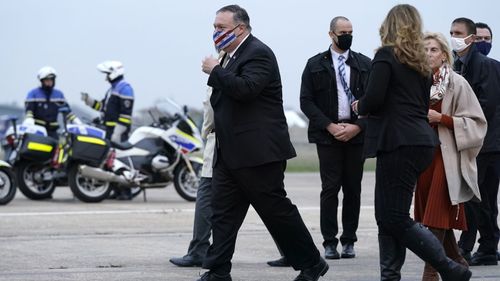 U.S. Secretary of State Mike Pompeo, left, walks to a motorcade vehicle after stepping off a plane at Paris Le Bourget Airport, Saturday, Nov. 14, 2020, in Le Bourget, France.