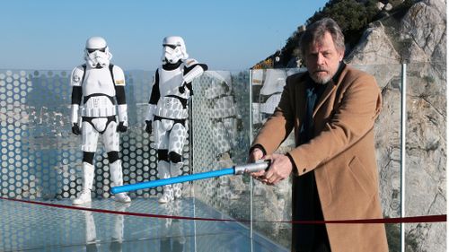Mark Hamill pretended to cut ribbon at Gibraltar Skywalk with his Luke Skywalker lightsaber (AAP)