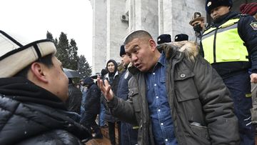Protesters talk to each other as they gather in support of Kazakh opposition and against deploying Kyrgyzstan&#x27;s troops to Kazakhstan during a rally in Bishkek, Kyrgyzstan, Friday, Jan. 7, 2022. 