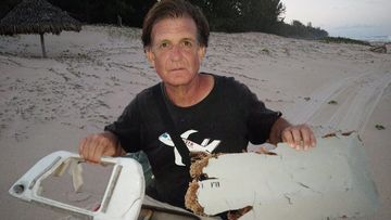 Blaine Gibson holding new pieces of debris possibly belonging to the missing Malaysian Airlines plane MH370, found on Nosy Boraha Island, Madagascar. (AAP)