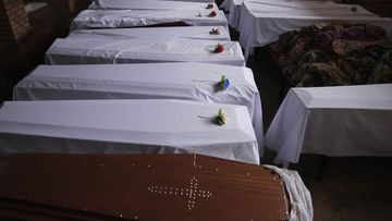 Coffins containing newly discovered remains of victims of the 1994 genocide arranged before a funeral ceremony, in a Catholic church, in Nyamata, Rwanda.