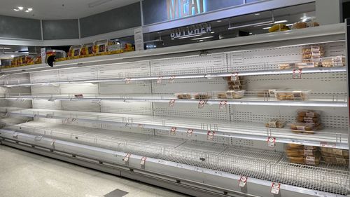 Empty supermarket shelves in Coles