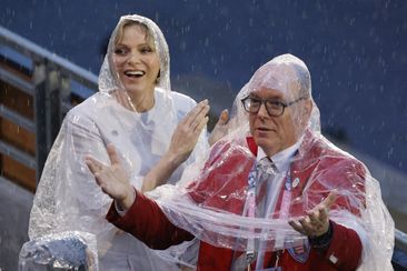 Monaco&#x27;s Prince Albert II, right  and Princess Charlene gesture, in Paris, France, during the opening ceremony of the 2024 Summer Olympics, Friday, July 26, 2024. (Ludovic Marin/Pool Photo via AP)
