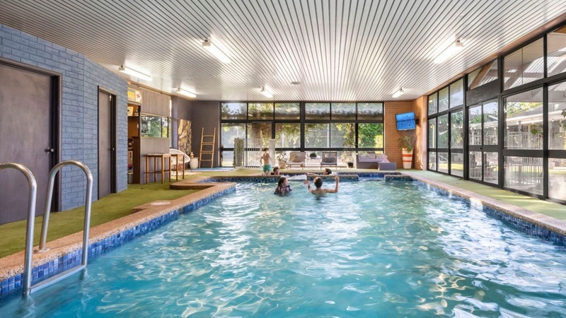 Family retreat listed for under $1 million with an indoor pool and tennis court