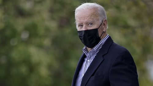 President Joe Biden look to the media as he leaves St. Edmund Roman Catholic Church in Rehoboth Beach, Del., Saturday, Nov. 6, 2021. (AP Photo/Carolyn Kaster)