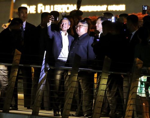 Kim Jong-un and Singapore Foreign Minister Vivian Balakrishnan (left) take selfies on the Jubilee bridge. Picture: AAP