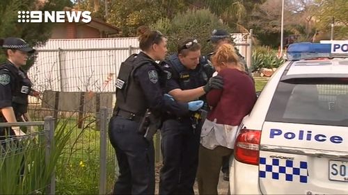 Police arrived at the Edith Street home to find a man with wounds to his back and a woman with cuts to her hands.