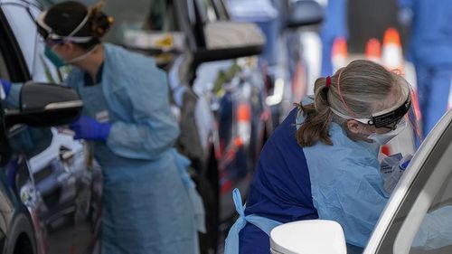 Staff collect samples at a drive-through COVID-19 testing clinic at Bondi Beach.