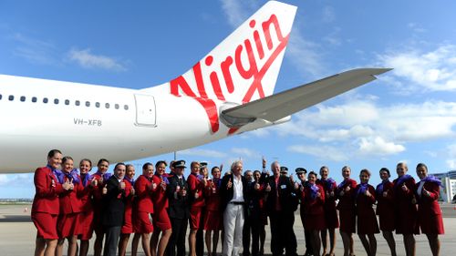 Richard Branson stands amongst Virgin Australia staff. (AAP)
