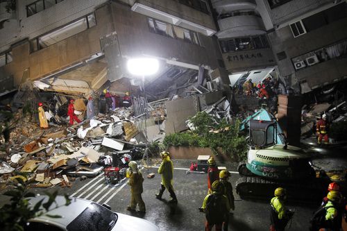 Rescue workers have worked through the night to find people trapped in the building. (AAP)