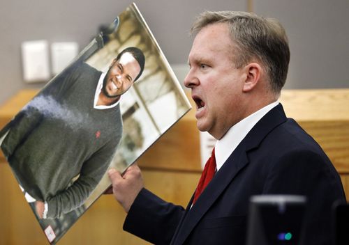 Assistant District Attorney Jason Hermus waves a photo of Botham Jean at the jury as he presents his closing arguments in Amber Guyger's murder trial in the 204th District Court at the Frank Crowley Courts Building in Dallas. Guyger shot and killed Botham Jean, an unarmed 26-year-old neighbour in his own apartment last year. She told police she thought his apartment was her own and that he was an intruder.