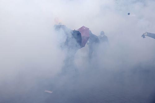 Youths advance though tear gas during a protest Thursday, April 6, 2023 in Nantes, western France.