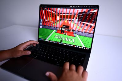 A child is seen playing a game on the Roblox platform. The platform will not be included in Australia's social media ban.