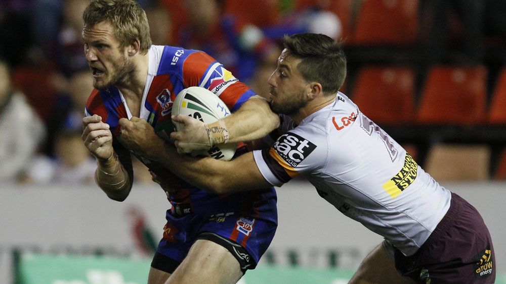 Knights fullback Nathan Ross take on the Brisbane defence. (AAP)