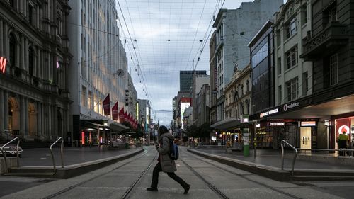 A person crossing Bourke Street mall on July 16, 2021 in Melbourne, Australia. Lockdown restrictions have come into effect across Victoria.