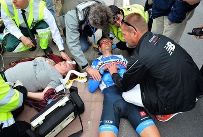 <b>An elderly cycling fan is fighting for her life in hospital after a sickening crash at a prestigious road race.</b><br/><br/>The woman was standing on a traffic island at the Tour of Flanders when she was hit by Garmin-Sharp rider Johan Vansummeren.<br/><br/>Both were rushed to hospital and though Vansummeren has been cleared of serious injury, the spectator remains in intensive care.<br/><br/>Fans and officials are often in the line of fire during road races, as these videos prove.<br/><br/><br/><br/>