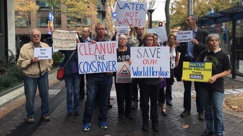 Protesters gather outside the NSW Land and Environmental Court in Sydney. (Image: AAP)