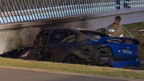 The burnt-out wreckage of the Ford Sedan. (9NEWS)