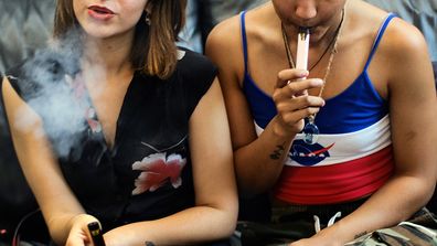 Two women vape at a party in Los Angeles. Last week, the Centers for Disease Control and Prevention in the US said more than three-quarters of the 805 confirmed and probable illnesses from vaping involved THC, the ingredient that produces a high in marijuana. 