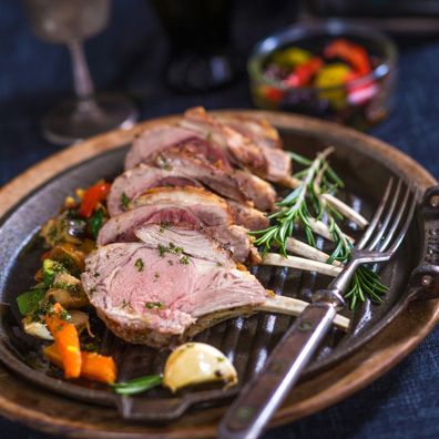 Rack of lamb with vegetables and herbs.