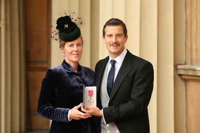 Bear Grylls and his wife Shara holding his OBE during an investiture ceremony at Buckingham Palace. 