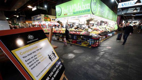 A sign on COVID-19 regulations is displayed at the Adelaide Central Market.