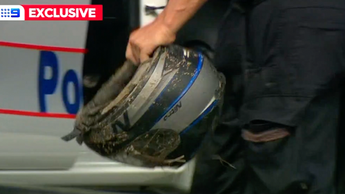 A helmet was found in the floodwaters of Gympie as the search for a missing motorbike rider continues.